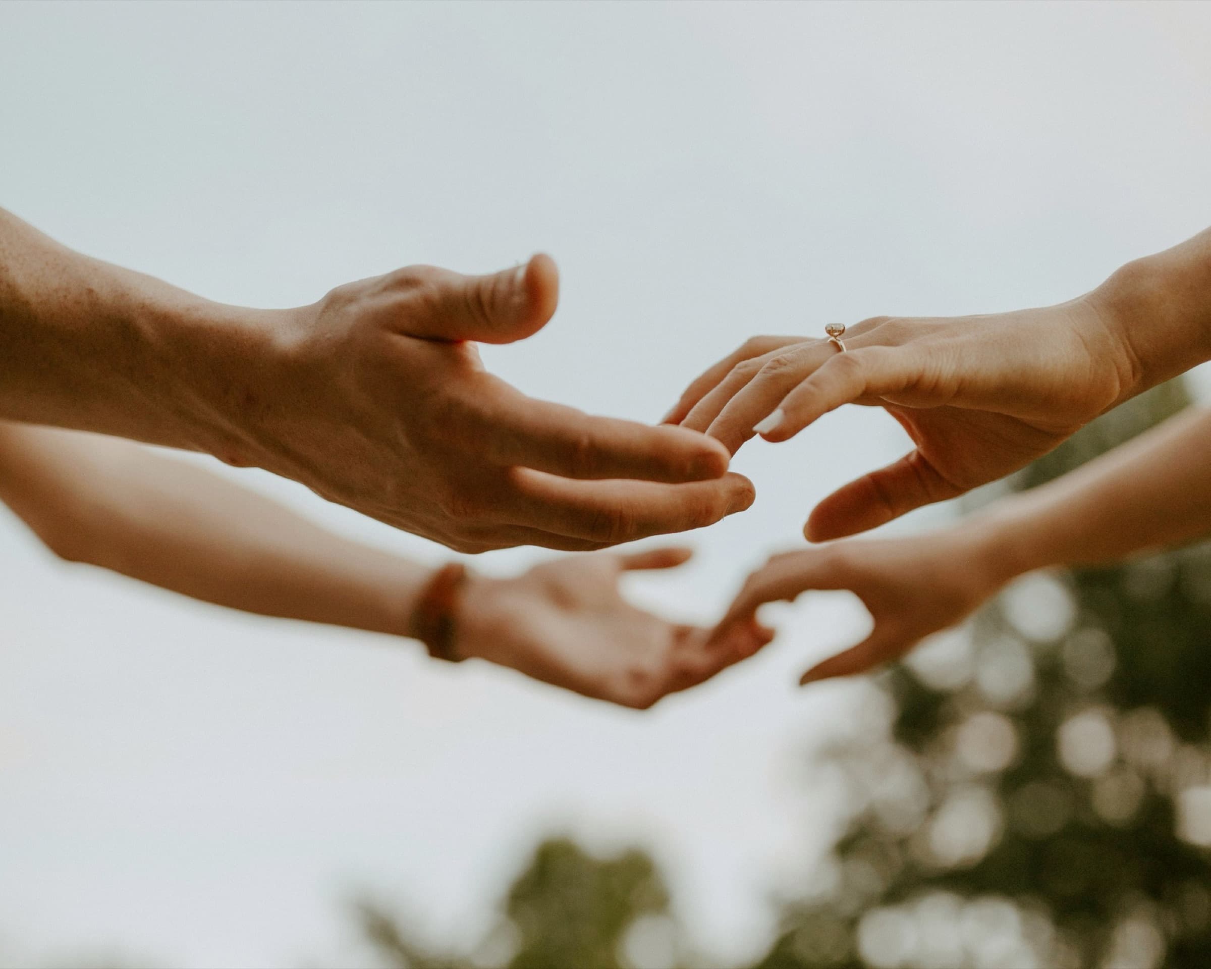 Two hands reaching for each other